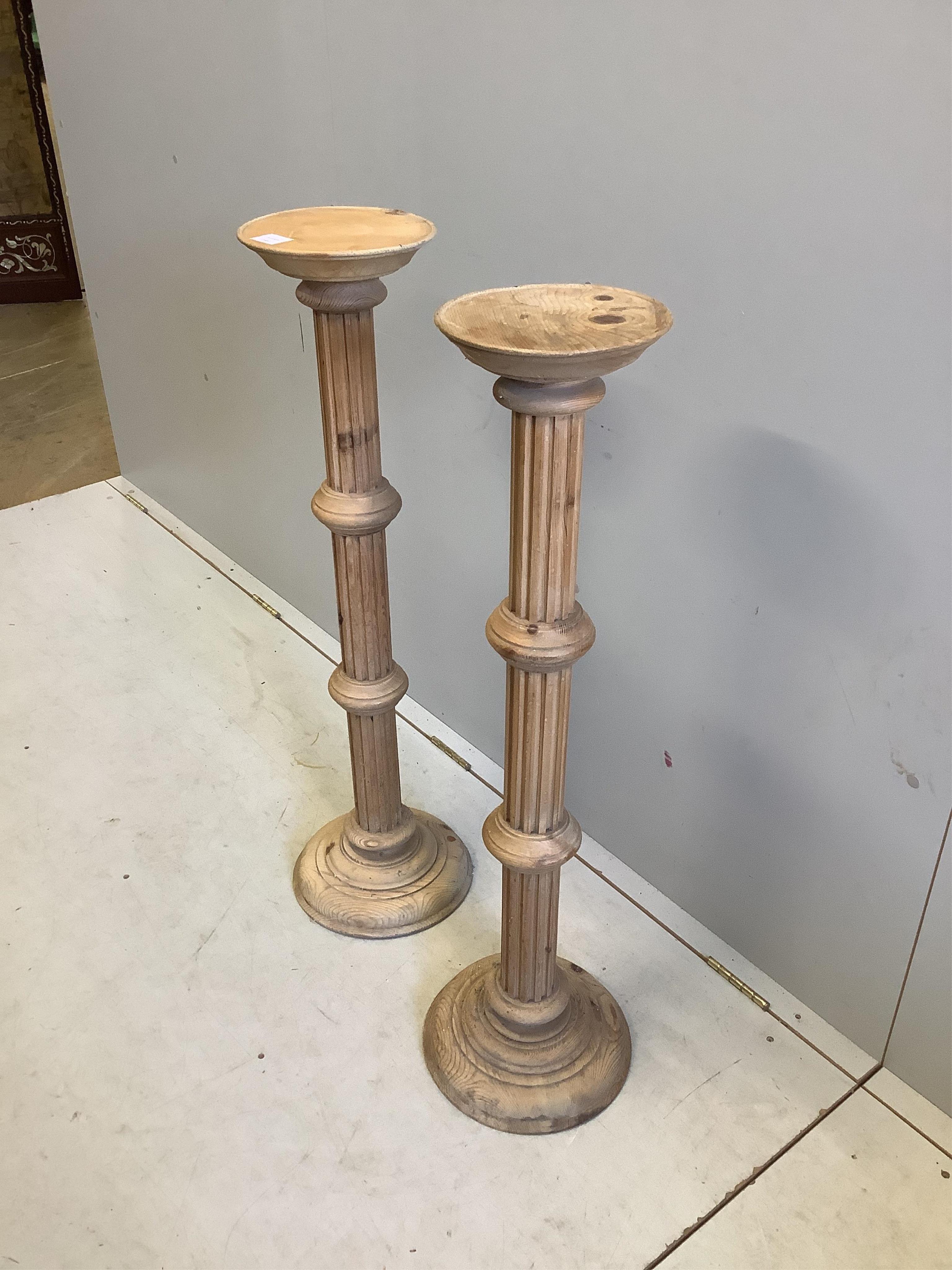 A pair of 19th century style stripped pine torcheres, height 100cm. Condition - fair